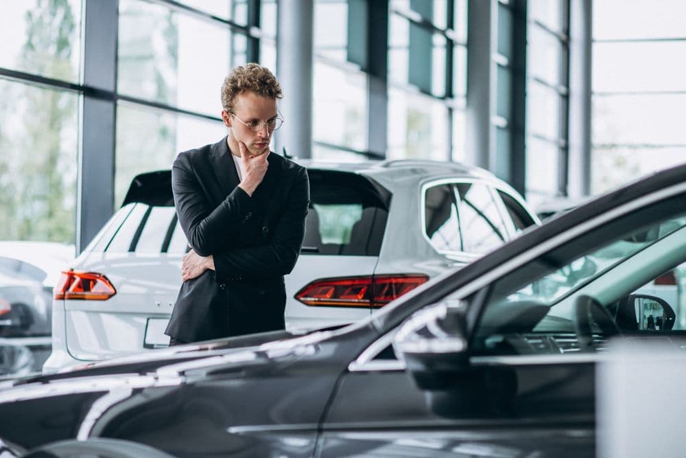 man-looking-car-thinking-purchase.jpg