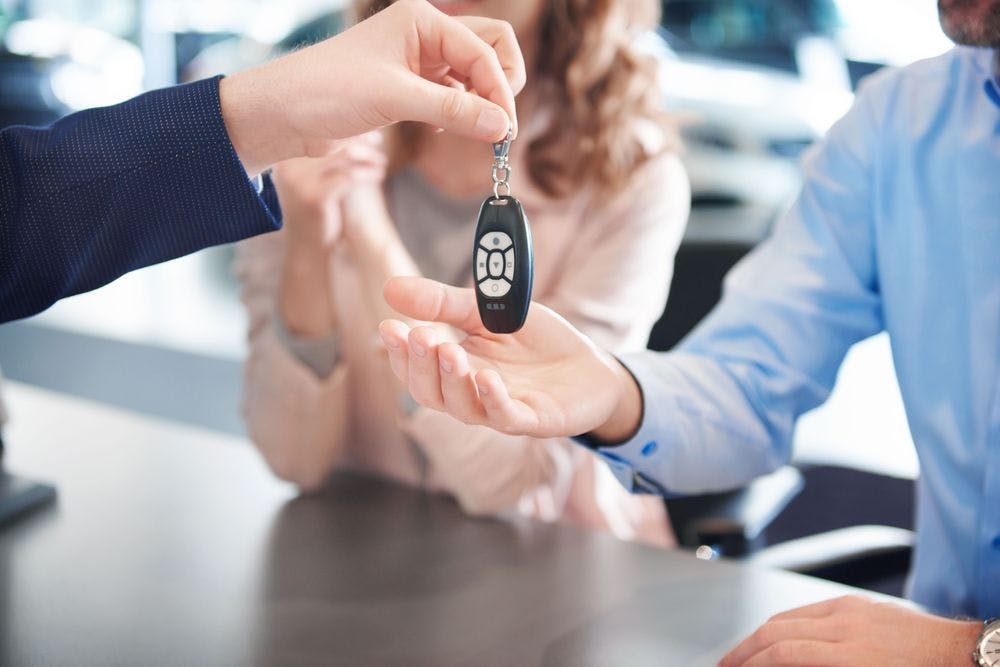 close-up-car-keys-passing-customers-hands.jpg